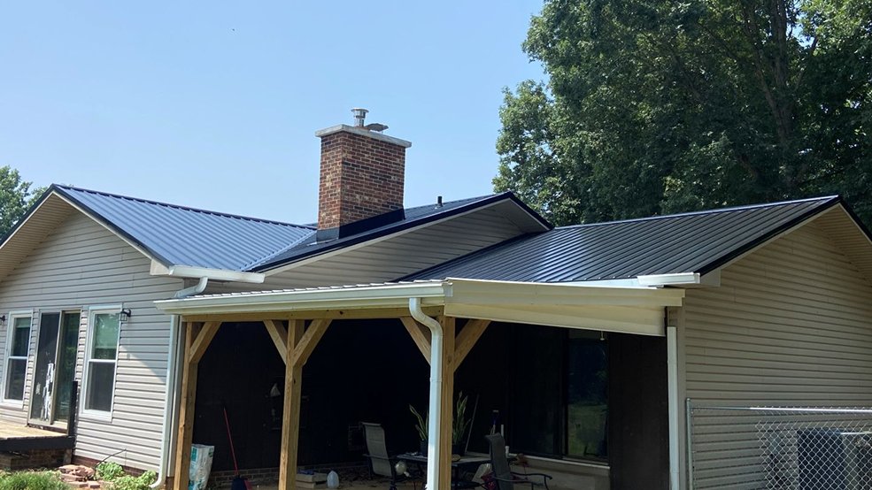 Black classic panel metal roof on a ranch home in open grassland in Smyrna, TN