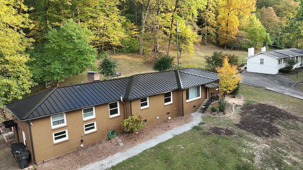 Black standing seam panel runs across a ranch home roof in Mt. Juliet, TN