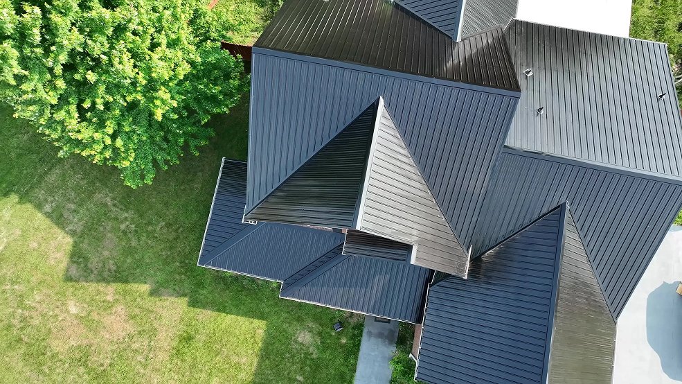 Black classic panel metal roof and roofline over brick in Hendersonville, Tennessee