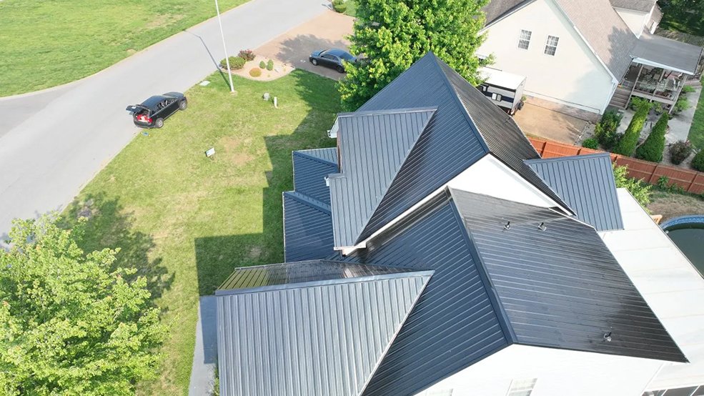 Angled view of a black classic panel metal roof on a brick home in Hendersonville, TN