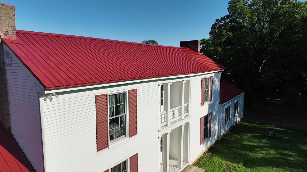 Classic panel metal roof on a red farm home in Hartsville, Tennessee