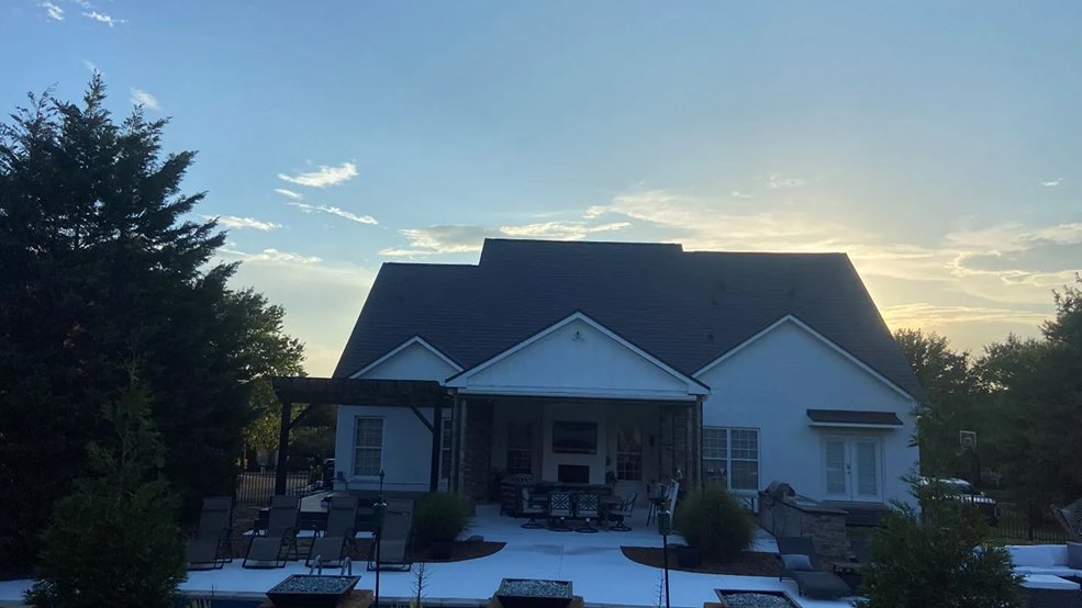 Black aluminum metal shingle roof on a suburban family home in Germantown, Tennessee
