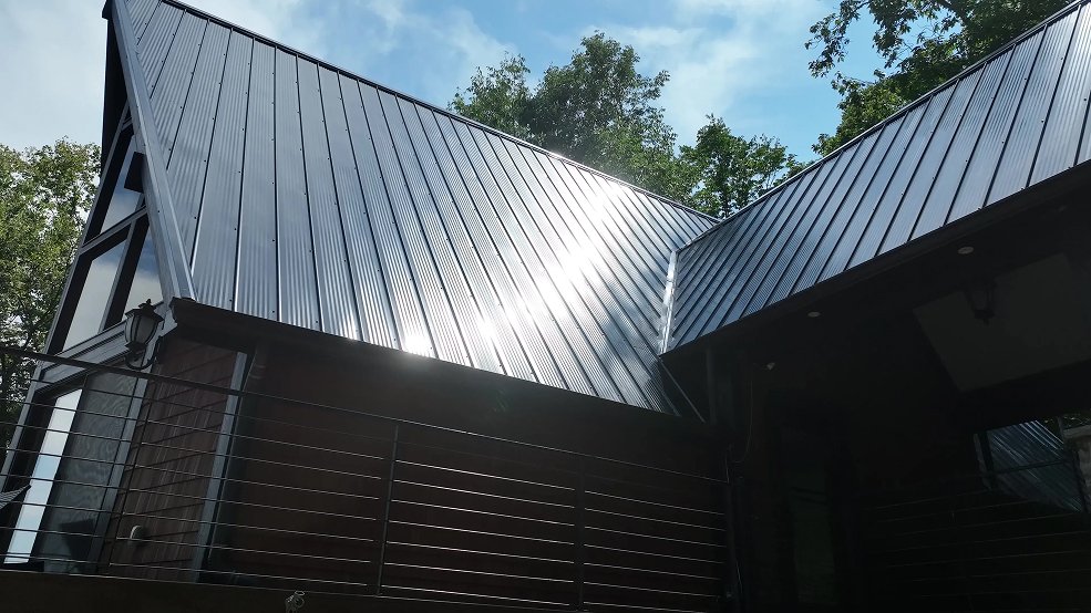 Black classic panel metal roof and low slope lines on a mid century cabin in Fairview, TN