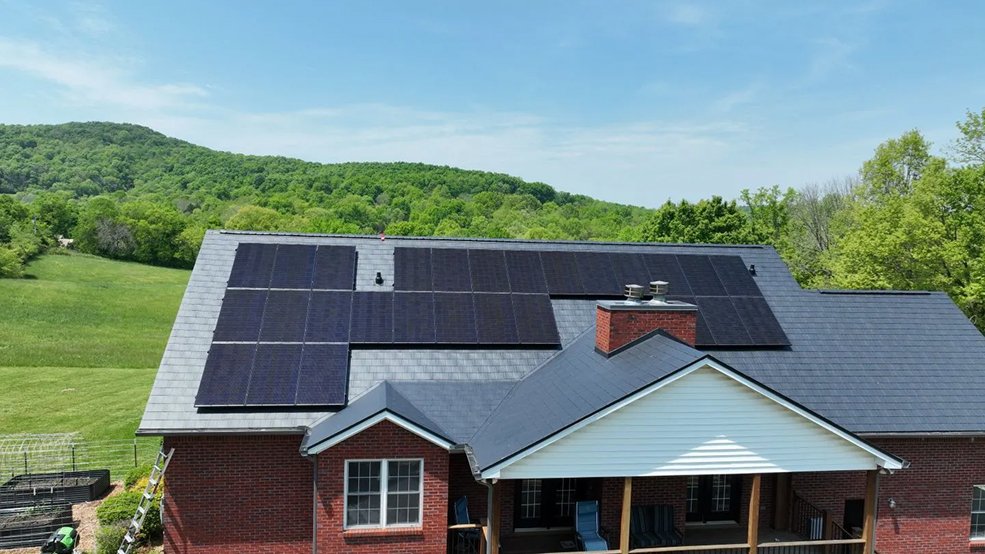 Black aluminum metal shingle roof carrying a solar panel system in Germantown, TN