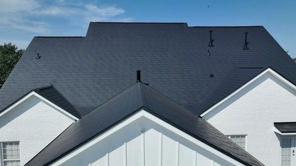 Black aluminum metal shingle roof and front gable on a family home in Germantown, TN