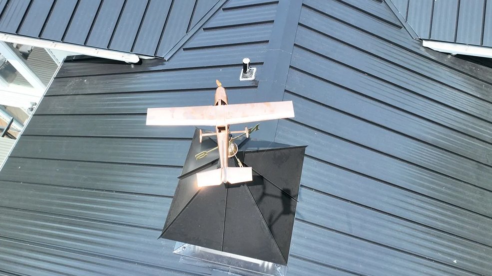 Black standing seam metal roof over a lakeside elevation in Hendersonville, TN