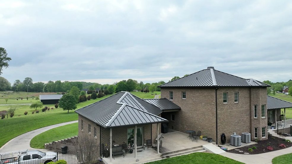Bronze standing seam metal roof across an estate roofline in Belle Meade, Tennessee