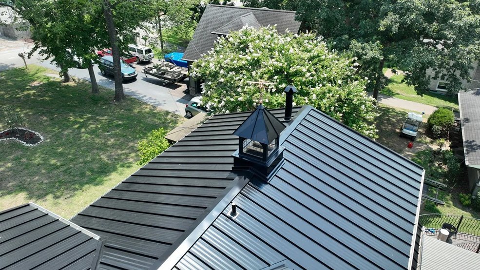Black standing seam metal roof with contrasting accent on a lake house in Hendersonville, TN