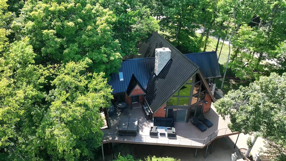 Black classic panel metal roof and clerestory windows on a mid century cabin in Fairview, TN