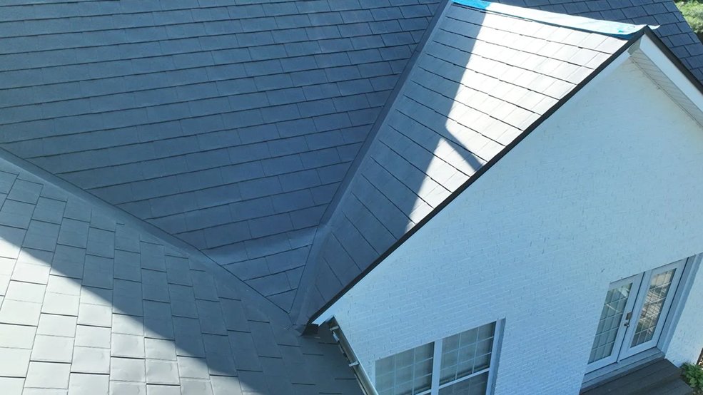 Black aluminum metal shingle roof and full elevation of a suburban home in Germantown, Tennessee