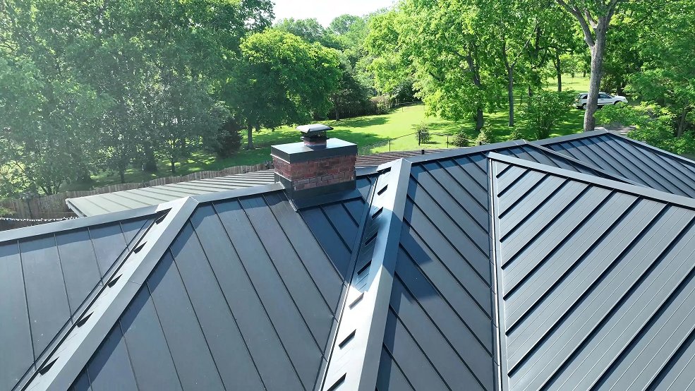 Gray standing seam panels across a country ranch roof in Cumberland City, TN