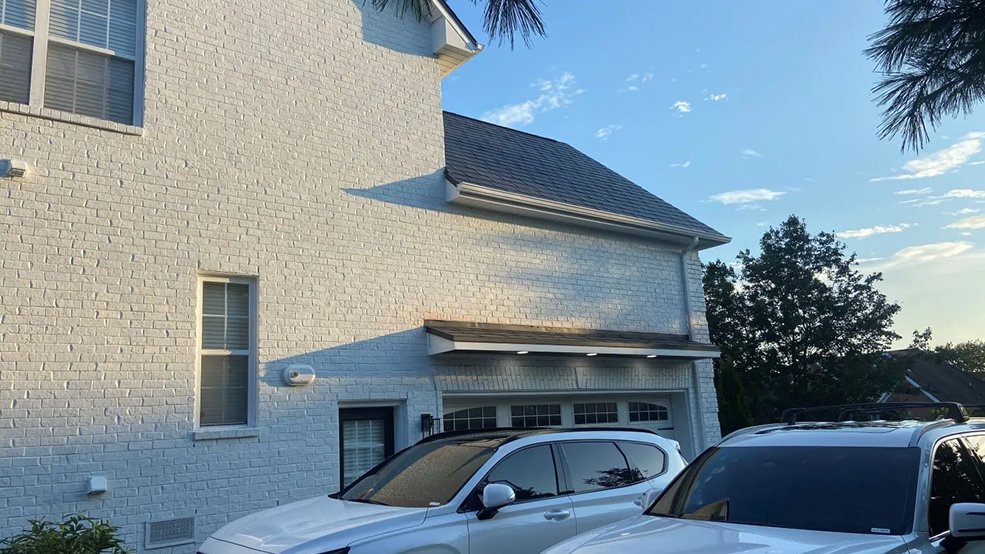 Black aluminum metal shingle roof on a suburban home in Germantown, Tennessee