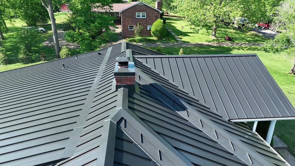 Gray standing seam metal roof and porch on a country ranch home in Cumberland City, Tennessee