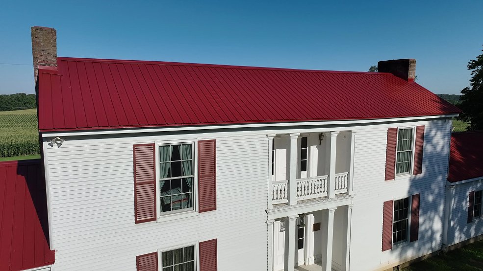 Classic panel metal roof on a red farm home in Hartsville, TN