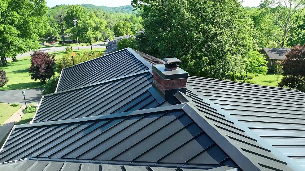 Gray standing seam roof and long ridge on a country ranch home in Cumberland City, Tennessee