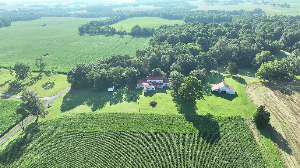 Red classic panel metal roof on a farm home in Hartsville, Tennessee