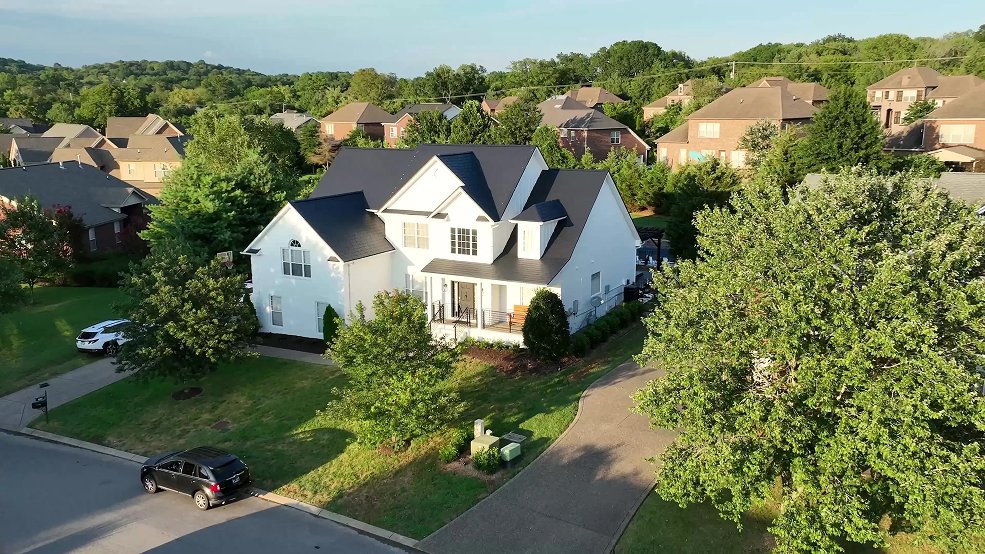 Black aluminum metal shingle roof on a two story suburban home in Germantown, TN