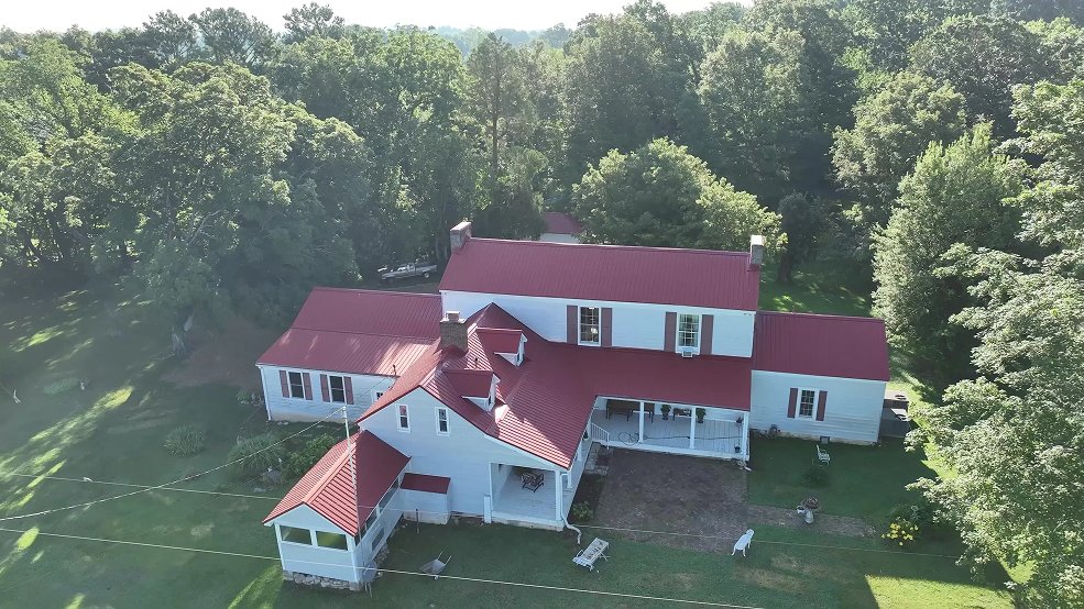 Red classic panel metal roof and farm outbuilding in Hartsville, Tennessee