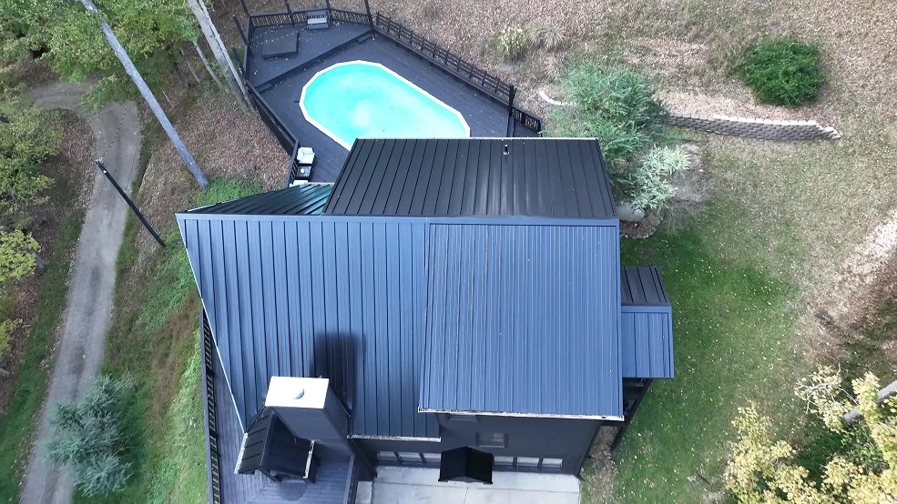 Black standing seam metal roof on a mid century modern home in Nashville, Tennessee
