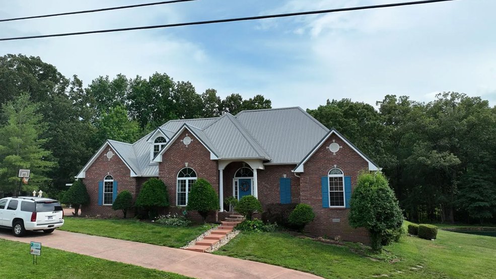 Silver standing seam metal roof on a family home in Forest Hills, Tennessee