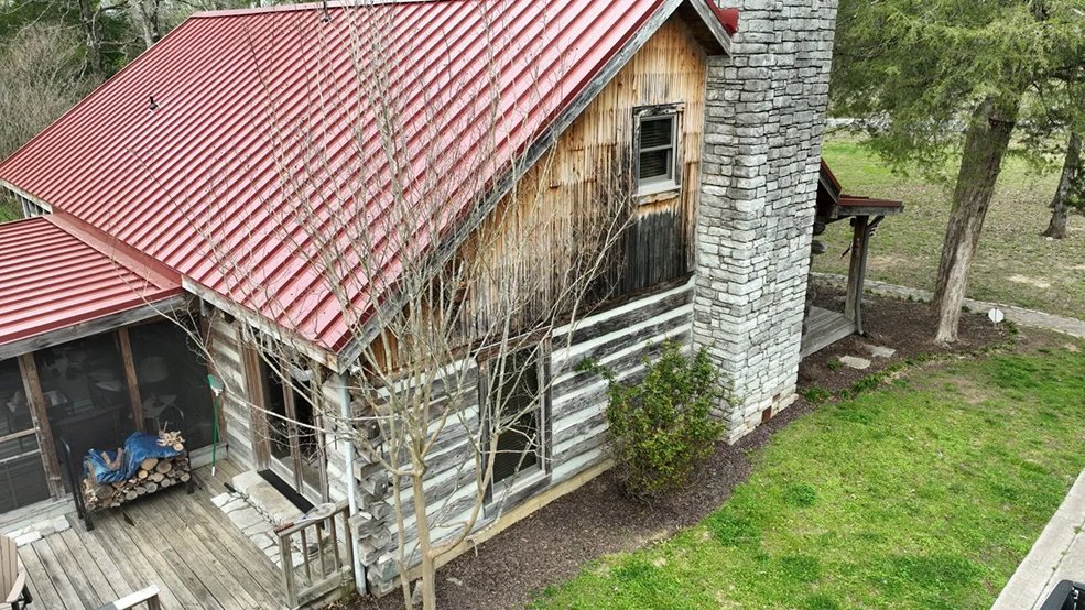Red classic panel metal roof on a cabin home in Sparta, Tennessee