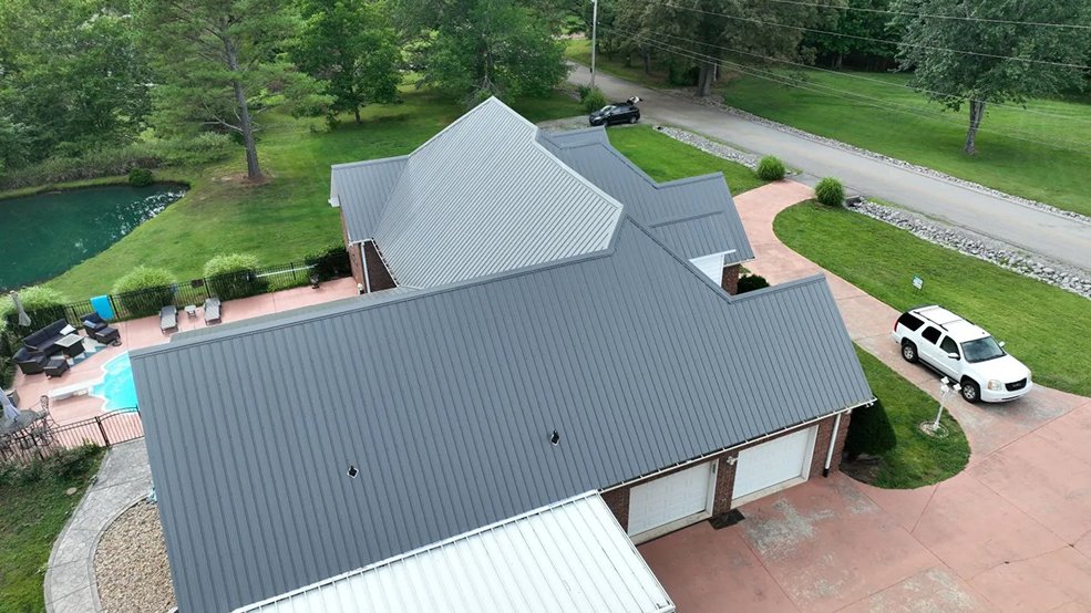 Silver standing seam metal roof and front gable on a family home in Forest Hills, TN