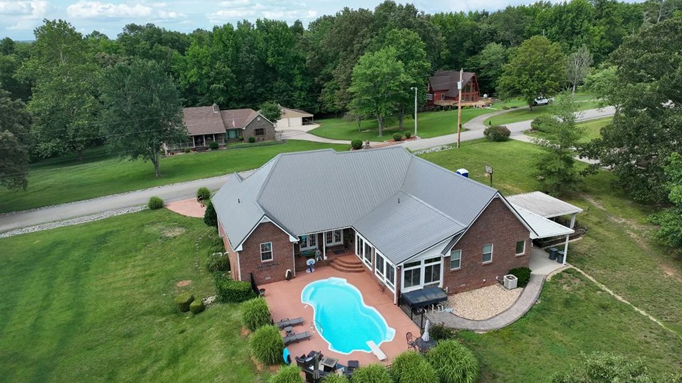Silver standing seam metal roof across a family home in Forest Hills, Tennessee