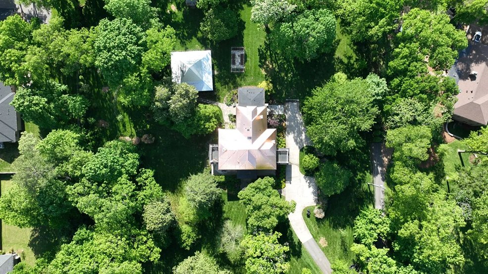 Copper standing seam metal roof on a century old stone home in Franklin, Tennessee