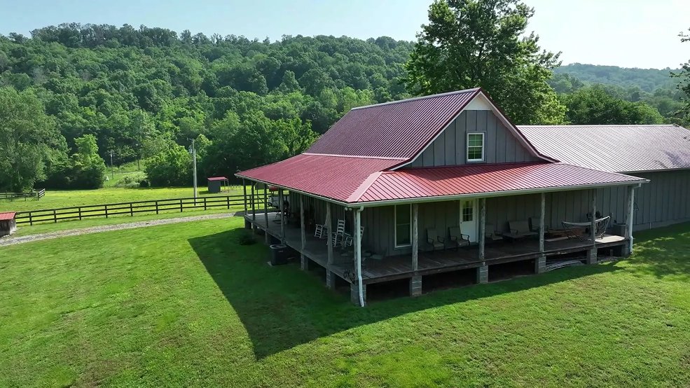 Classic barn red panel metal roof on a Tennessee farm home in Hartsville