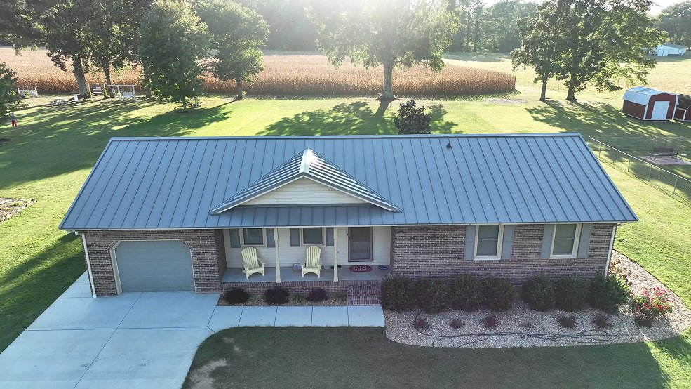 Gray standing seam metal roof and farm outbuildings in Lebanon, TN