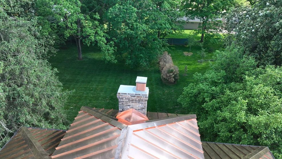 Copper standing seam metal roof and stonework detail in Franklin, TN