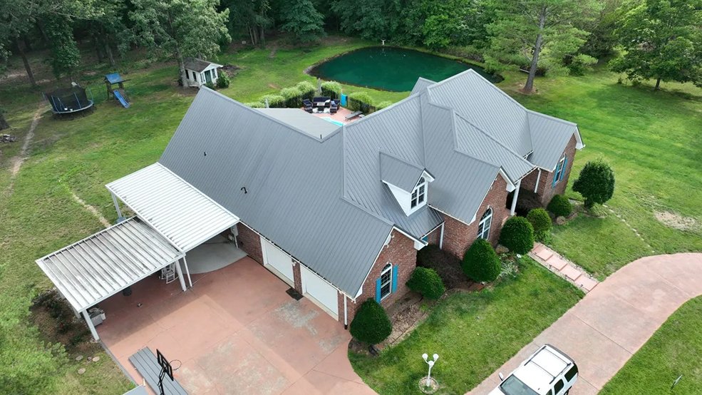Silver standing seam metal roof on a family home in Forest Hills, Tennessee