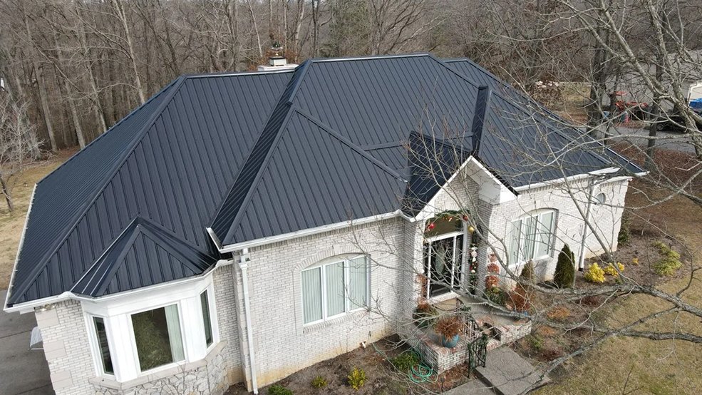 Black standing seam metal roof and side elevation of a ranch home in Mt. Juliet, Tennessee