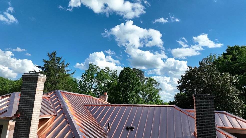 Copper standing seam roof and dormer on a historic stone home in Franklin, Tennessee