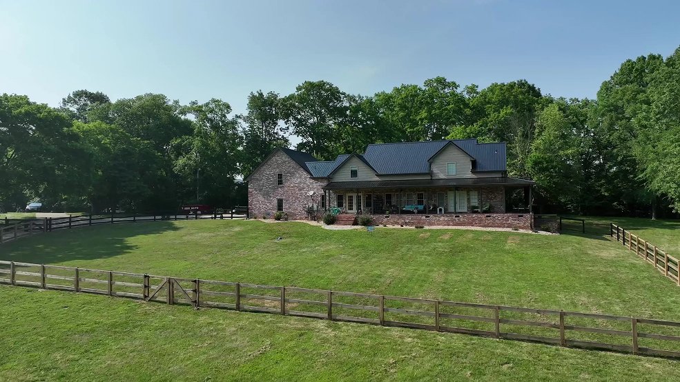 Black standing seam metal roof on a country home above open pasture in Columbia, TN