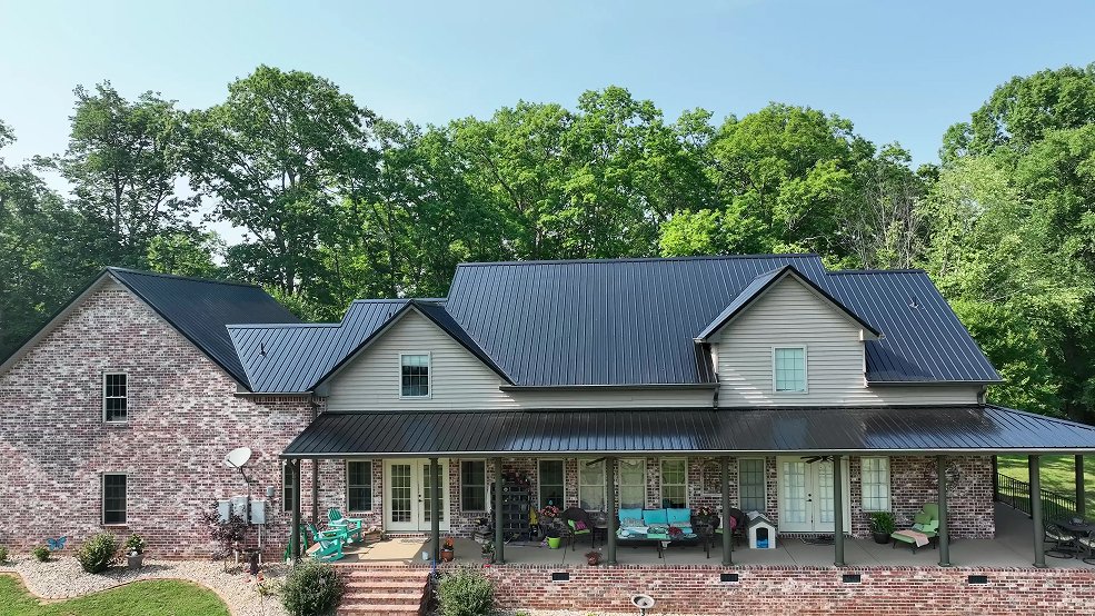 Black standing seam metal roof on a hilltop country home in Columbia, Tennessee