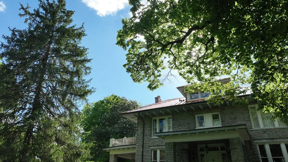 Copper standing seam metal roof on a historic stone home in Franklin, Tennessee