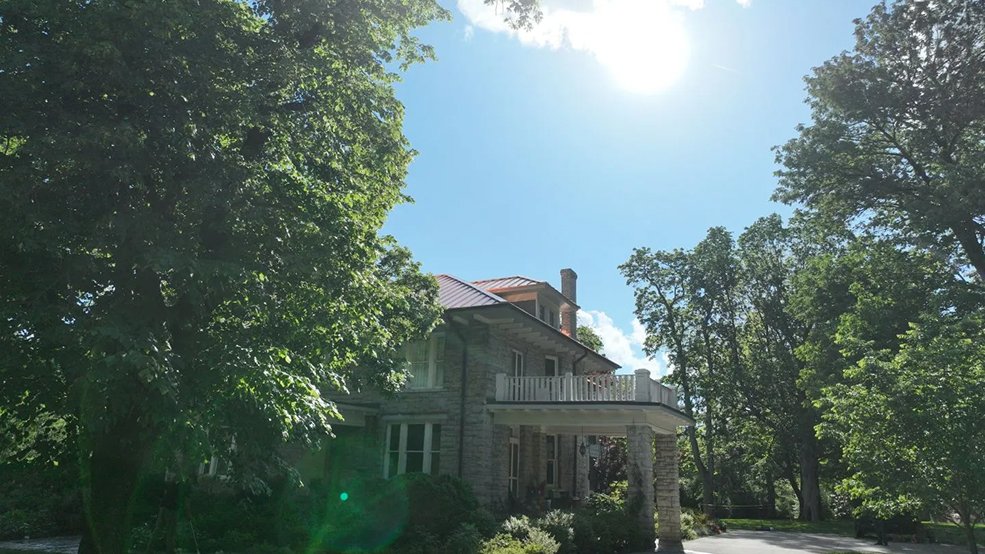Copper standing seam roof panels weathering on a stone home in Franklin, TN