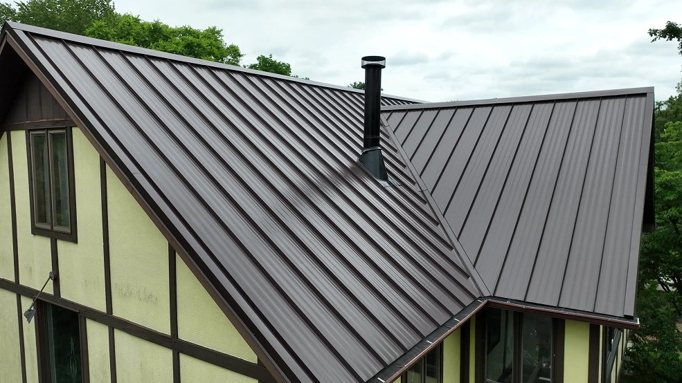 Mansard brown standing seam roof and half timbering on a Tudor home in Brentwood, Tennessee