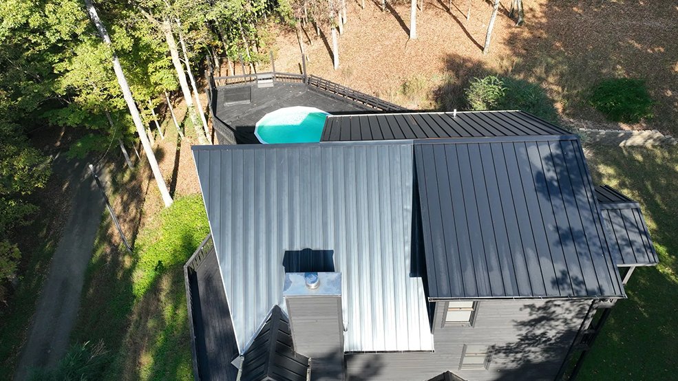 Black standing seam metal roof panels with concealed fasteners