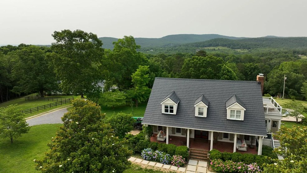 Black steel shingles paired with standing seam panels on one Tennessee roof