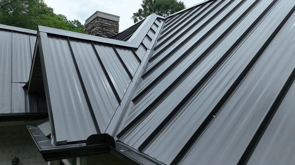 Black standing seam metal roof with matching gutters in Middle Tennessee