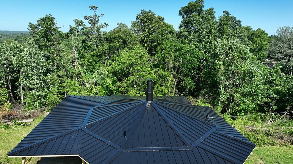 Black standing seam metal roof on a low profile home in Nolensville, Tennessee