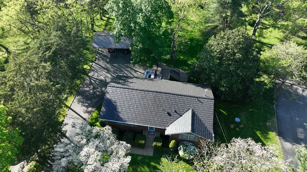 Full angled view of a gray metal roof on a blue home in Portland, Tennessee
