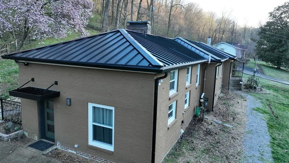 Black standing seam metal roof panels across a Tennessee roof