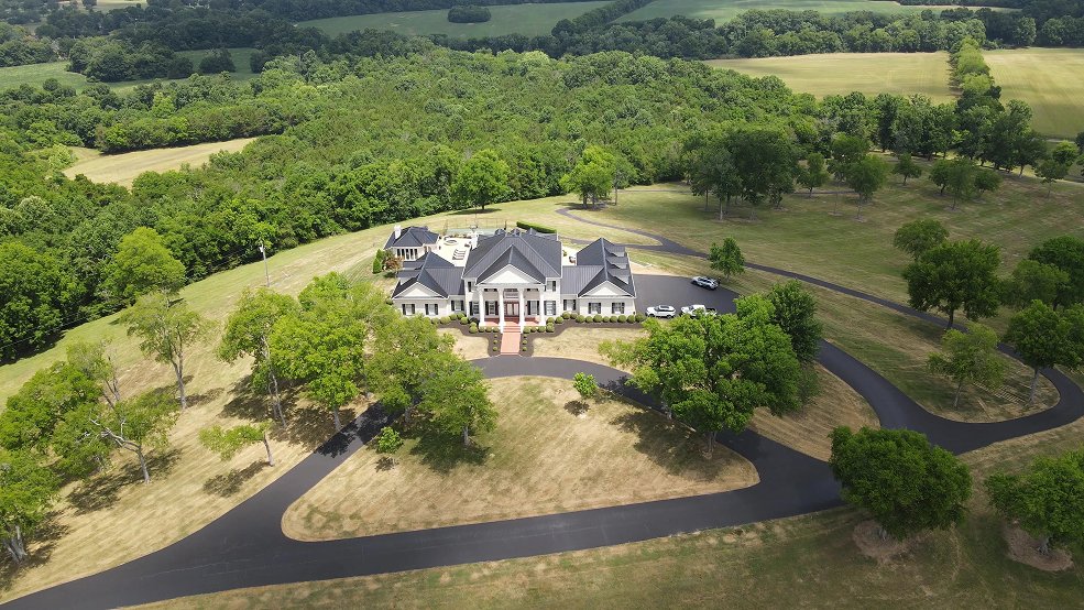Black standing seam metal roof and multiple gables on a large Nashville home