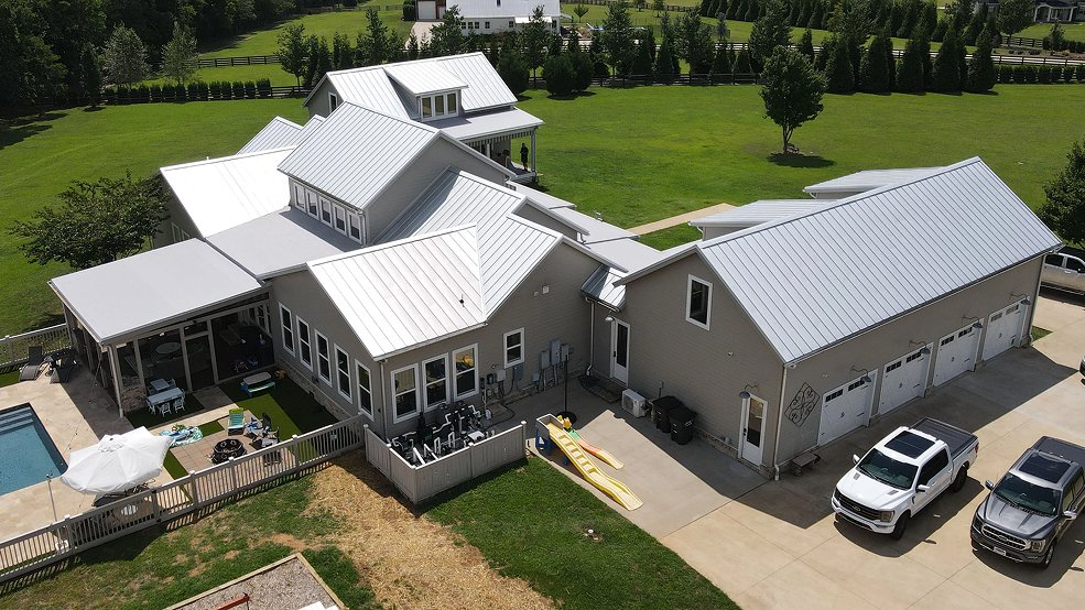 White traditional exposed fastener metal panel roof on a Tennessee home