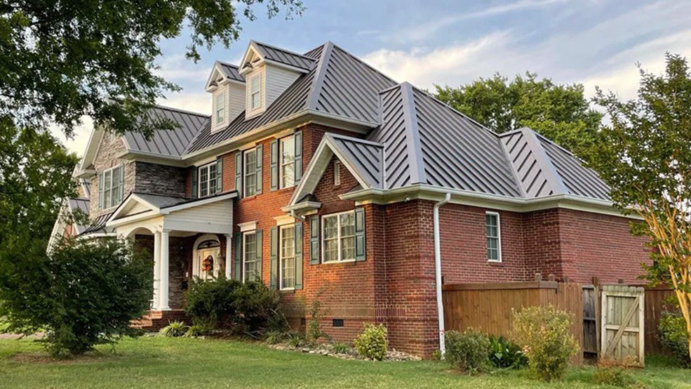 Gray standing seam metal roof across a large Middle Tennessee home