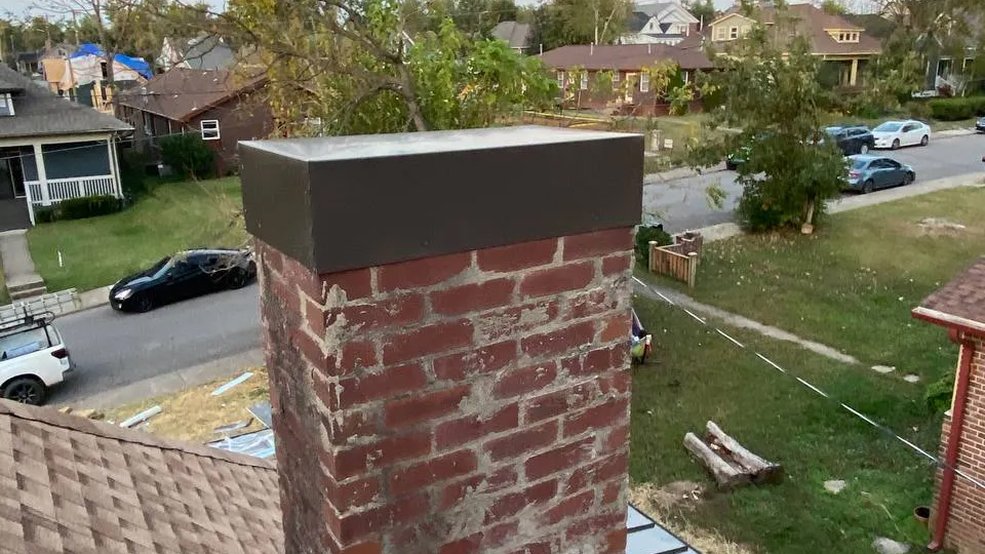 Custom fabricated metal chimney cap on a Tennessee roof