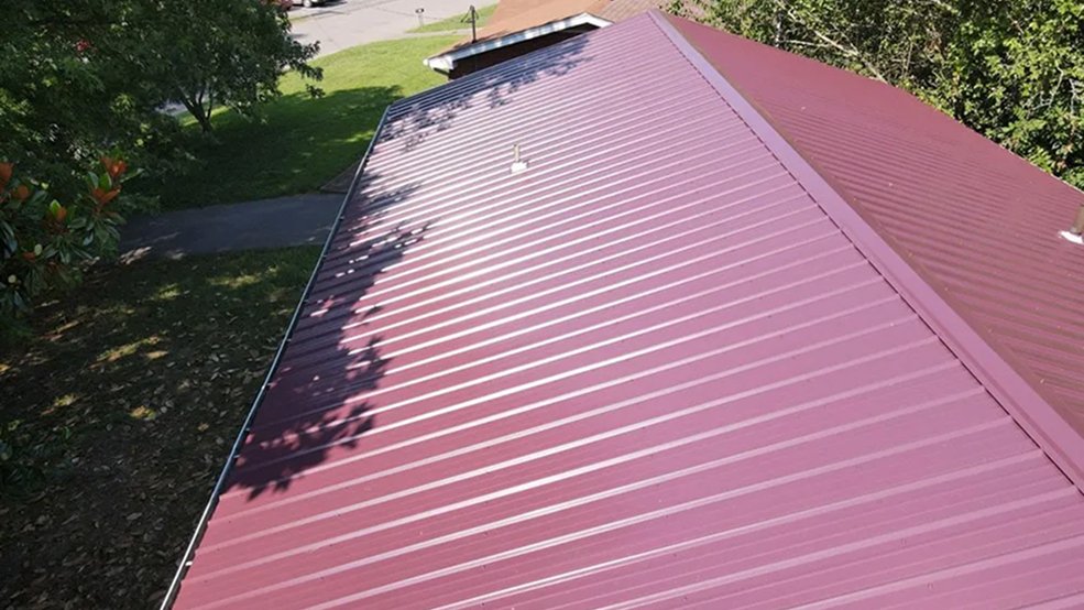 Red traditional exposed fastener metal panel roofing